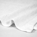 Closeup of 12x12 Economy White Washcloths in Bulk