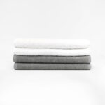 Stack of 12x44 White and Grey Fitness Towels