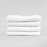 Stack of 15x25 Economy White Hand Towels in Bulk